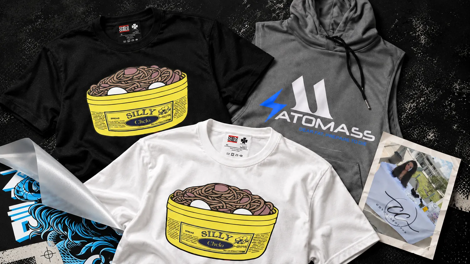 Printed work from Amour Lab: a black tee and a white tee with a yellow noodle-bowl graphic, and a gray sleeveless hoodie with a white and blue logo